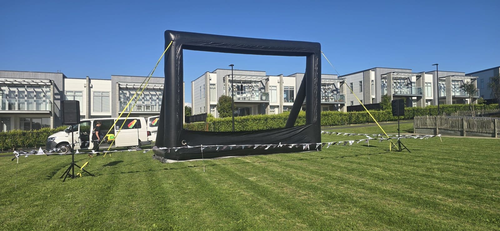 Night Owl Cinema crew setting up an inflatable outdoor movie screen before an event